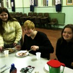 Youth Group Members Eating at Table